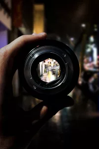 Person Holding Black Camera Lens